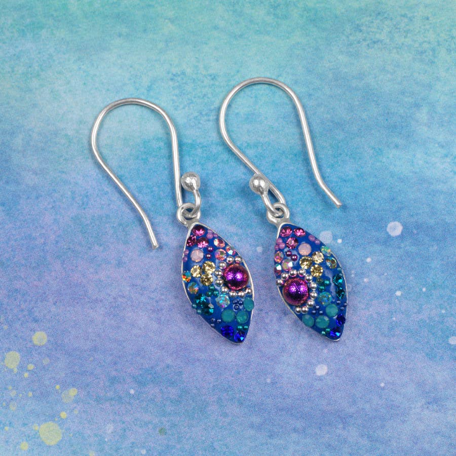 Colorful petite seed earrings by Mosaico Jewels, featuring vibrant gemstones and a unique leaf shape on a soft pastel background.