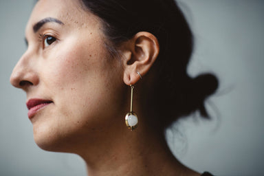 woman wearing Kinetic quartz drop earrings