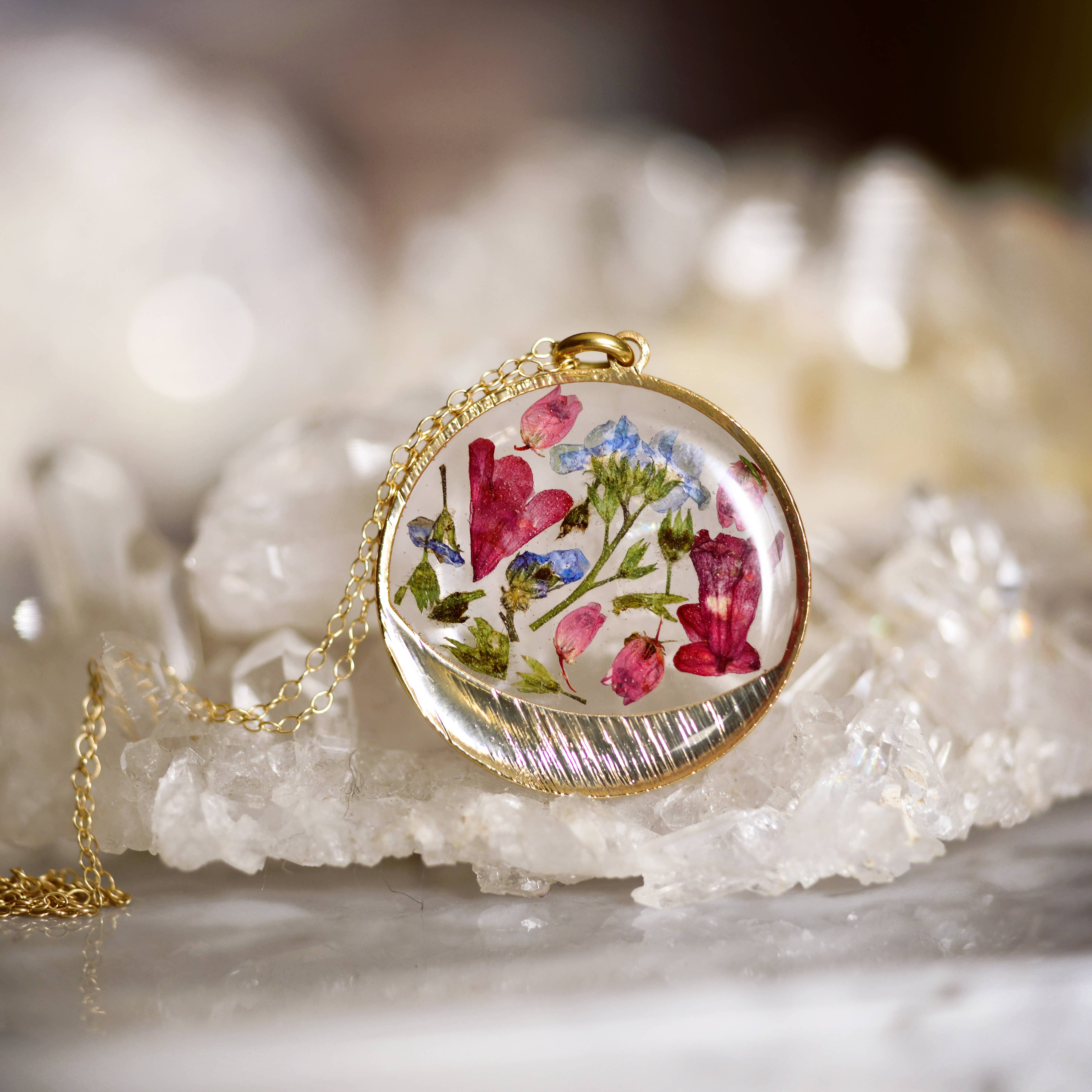 Close-up of the Garden Variety Flower Confetti Gold Moon Necklace showing the intricate gold plated moon frame.