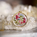 Close-up of the Garden Variety Flower Confetti Gold Moon Necklace showing the intricate gold plated moon frame.
