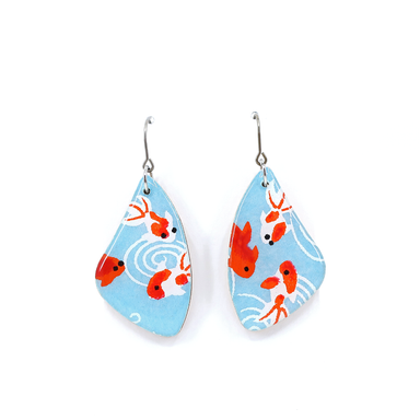 Close-up of mint blue goldfish titanium dangle earrings highlighting the unique craftsmanship and resin finish.