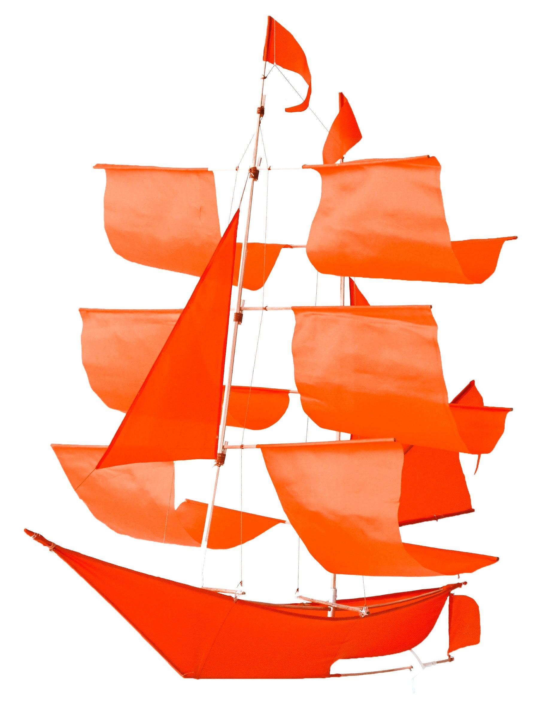 Bright red Sailing Ship Kite by Haptic Lab, featuring multiple sails and a sleek design, perfect for flying in strong winds.