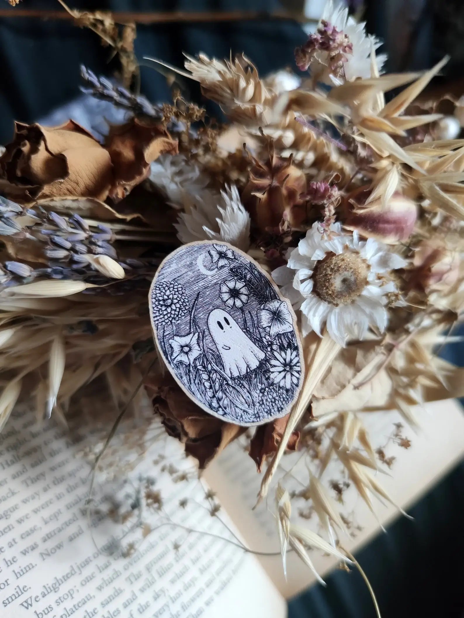 ghost wooden pin surrounded by dried flowers