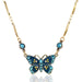 Teal Artisanal Golden Accented Butterfly Crystal Necklace featuring a rich teal hand enameled butterfly pendant, adorned with sparkling teal and golden crystal embellishments, on an antiqued brass chain.