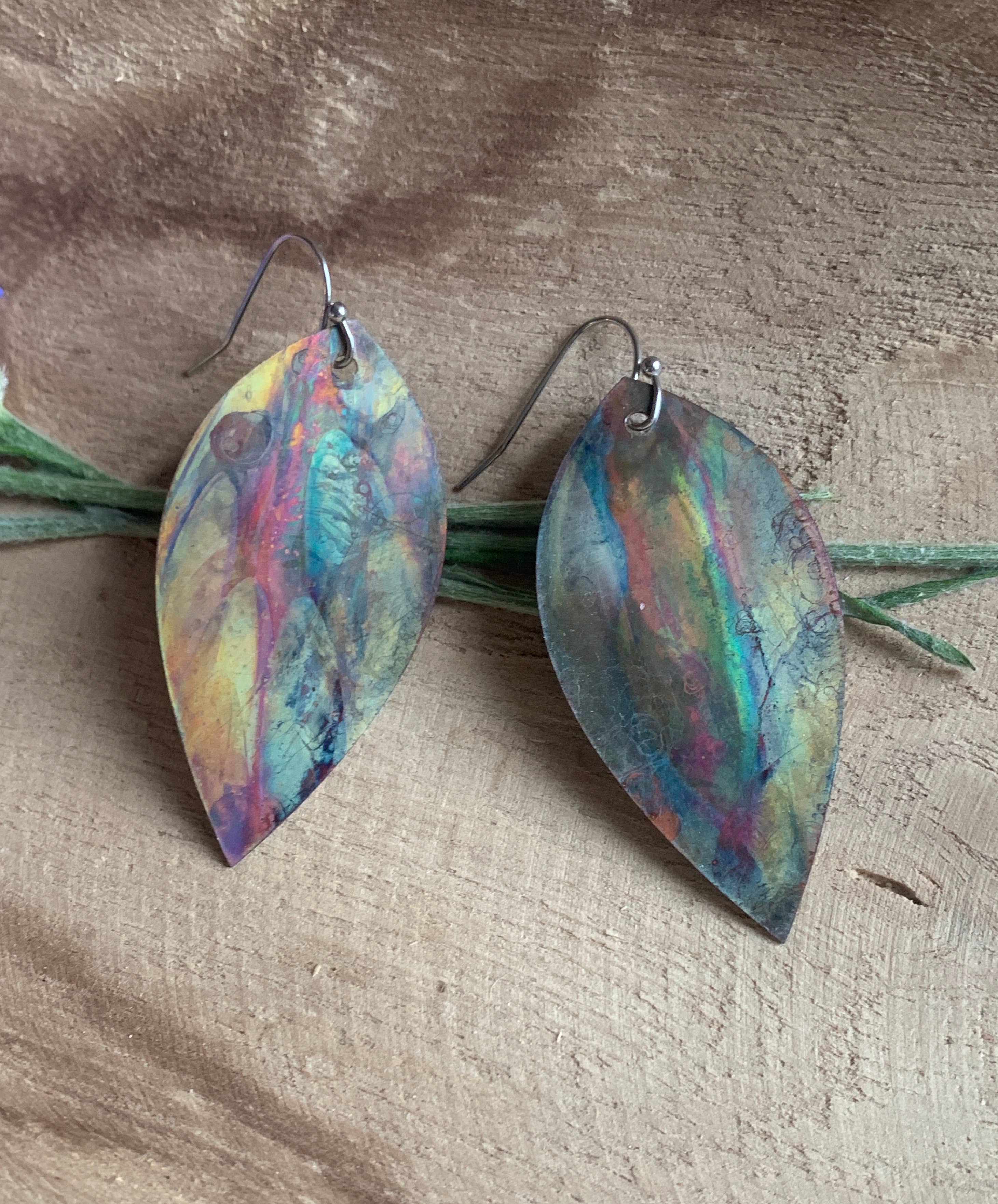 Botanical Large Leaf Fire Painted Copper Earrings beautifully hand-crafted with unique colors from the heat of the torch, showcasing their 2 1/4 inch long design and lightweight feel.