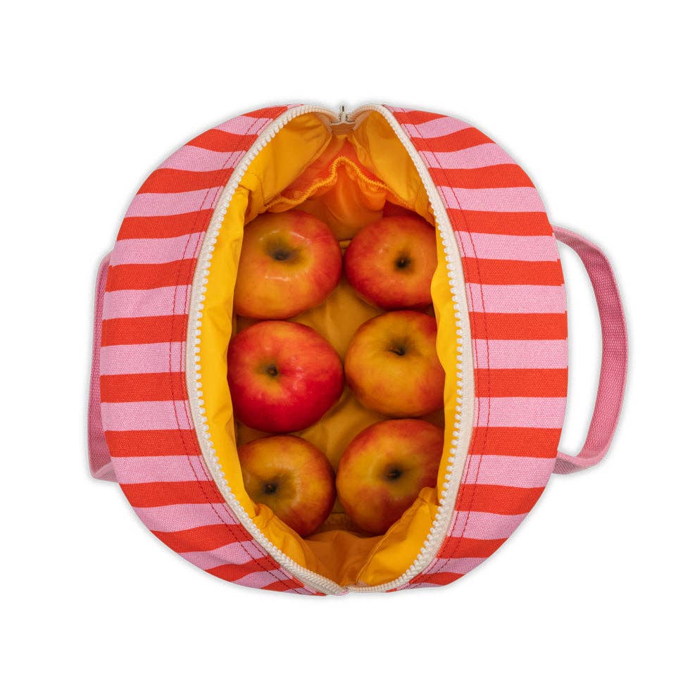Pink striped lunch bag filled with apples 