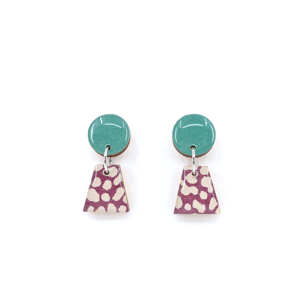 Close-up view of green and purple geometric titanium small drop earrings, showcasing the intricate design and materials like UV-cured resin and titanium posts.