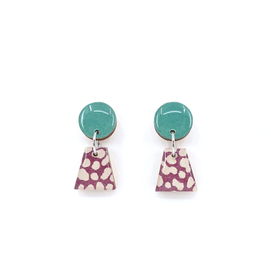 Close-up view of green and purple geometric titanium small drop earrings, showcasing the intricate design and materials like UV-cured resin and titanium posts.