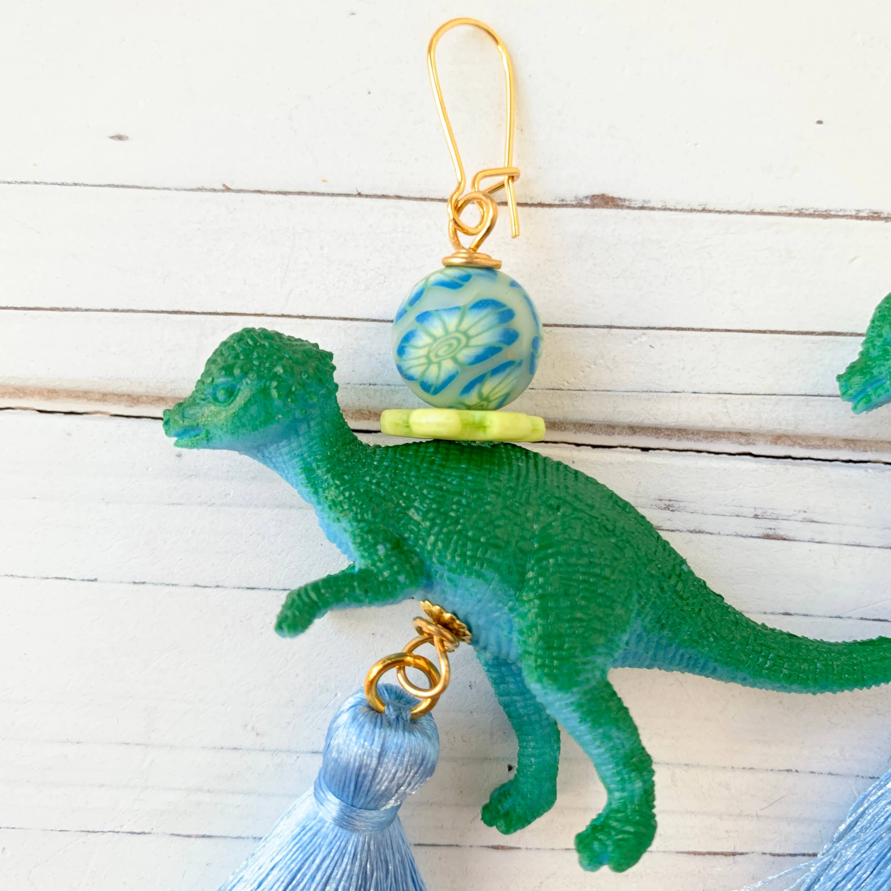 dinosaur drop earrings with blue tassel