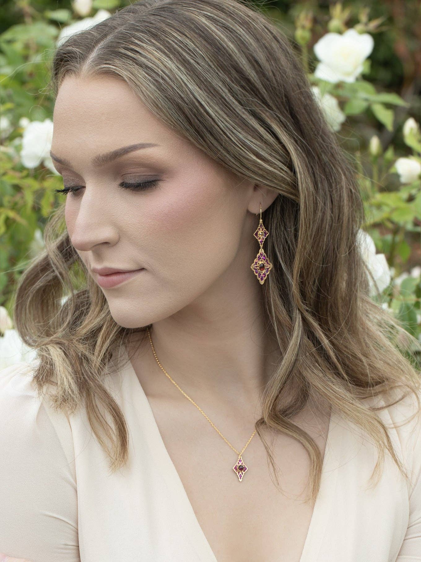 Esmeralda Earrings in action! Double-tiered drops that dance with delight – perfect for when you're ready to steal the spotlight with a cheeky flare.