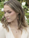 Esmeralda Earrings in action! Double-tiered drops that dance with delight – perfect for when you're ready to steal the spotlight with a cheeky flare.