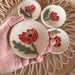 Individual Red Poppy Tea Rest mini dish held in a hand, showcasing the unique handcrafted detail by Tough Kitty Designs, ideal for spices and small items.