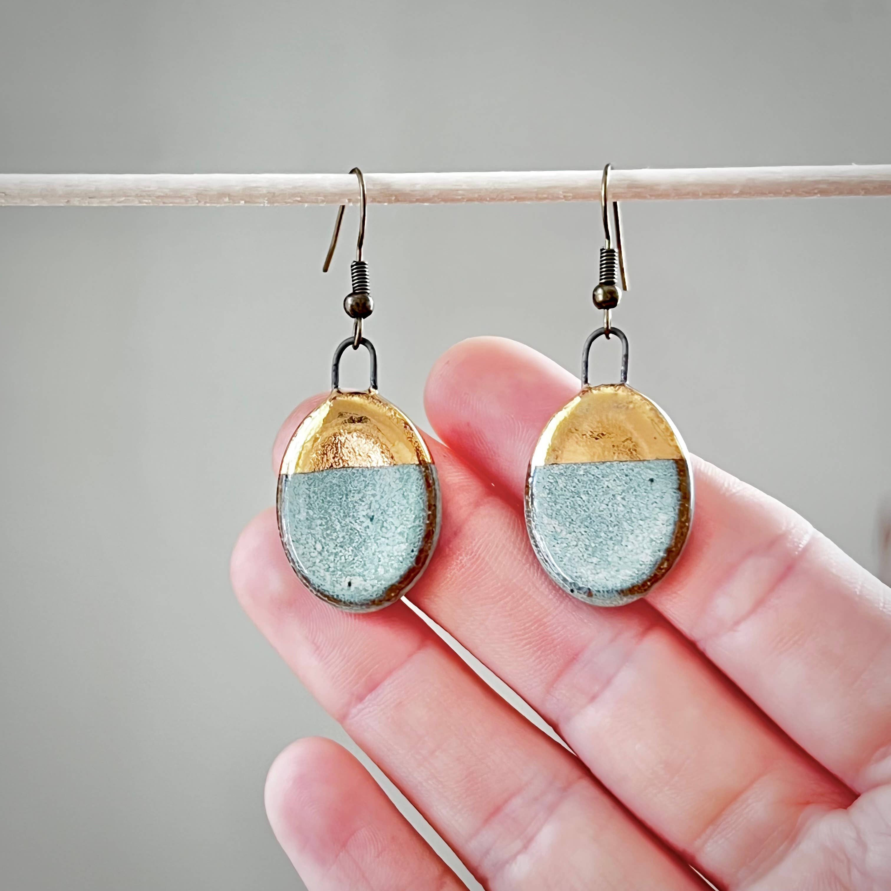 Turquoise Dipped Oval Gold Earrings by The Artifact House, showcasing a handmade design with a combination of turquoise and gold elements.