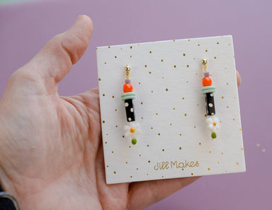 Close-up of the Black and White Polka Dot Earrings showcasing their charming whimsy, perfect for adding fun to your outfit!