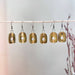 Collection of Olive Square Loop Ceramic Stoneware Earrings by The Artifact House hanging in a row, showing various angles and details.