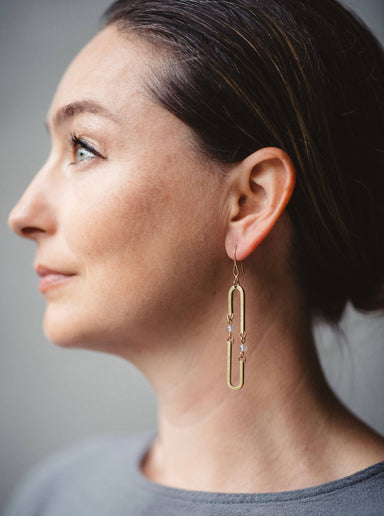 woman wearing Kinetic long oval earrings