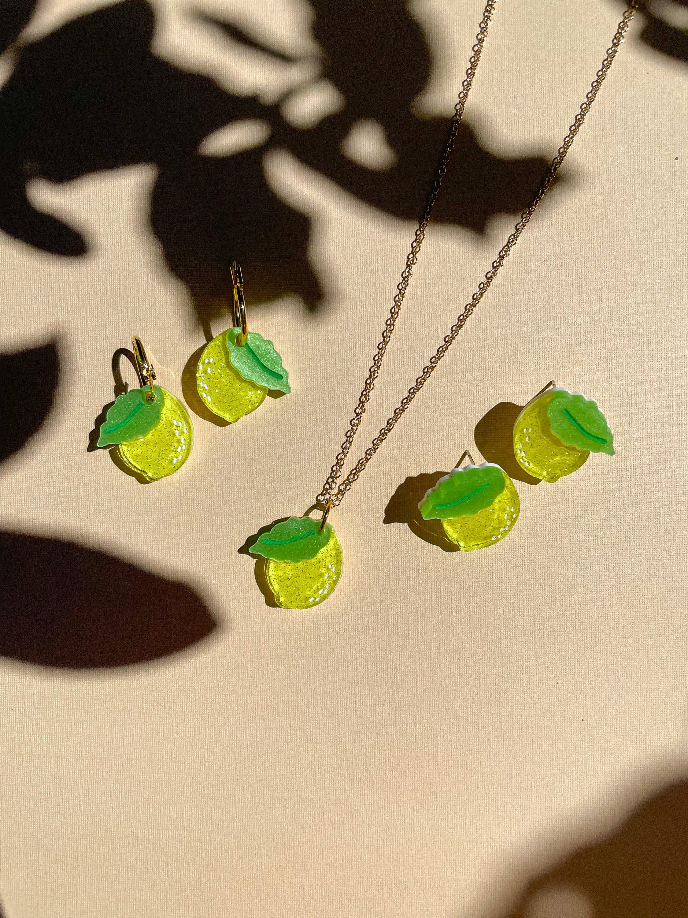 Mini Lemon Necklace by Sunnie Creative featuring a lemon-themed design with matching lemon earrings, showcased on a soft background.