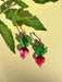 Ruby Radish Dangle earrings from Sunnie Creative, featuring vibrant pink radishes with green leaves, showcased against a light backdrop.