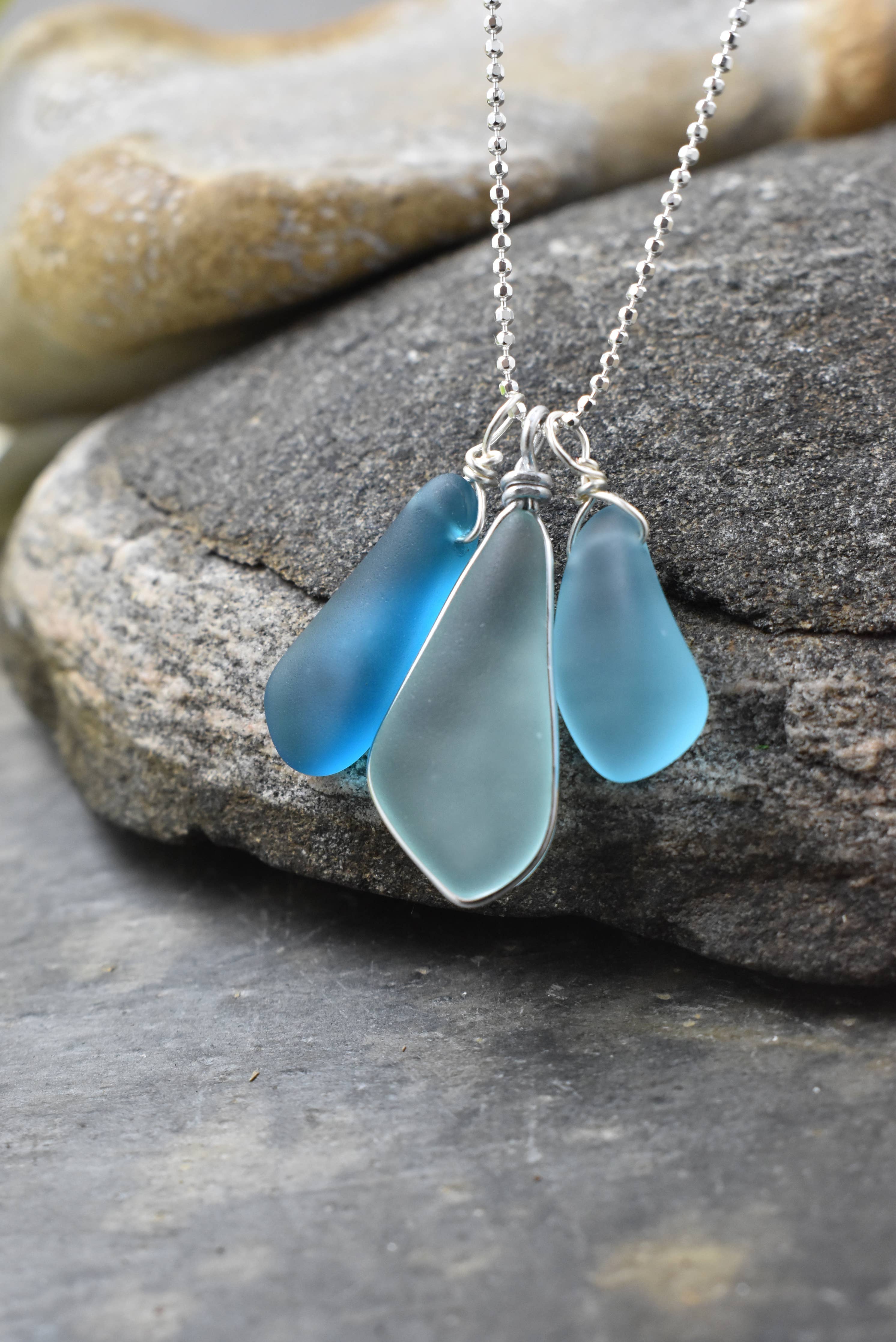 Elegant Blue Eco Glass Trio Sterling Silver Necklace showcasing three frosted glass drops, perfect for ocean enthusiasts, designed by Whitelotus Design.