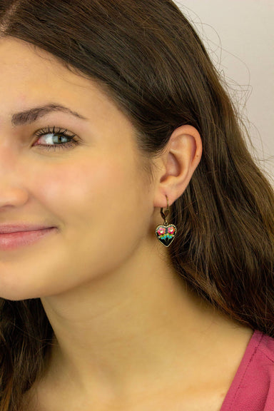 Model wearing Kahala Rose Jill's Garden Crystal Heart Charm Earrings, showcasing the colorful floral design and crystal accents, designed by Anne Koplik Designs.