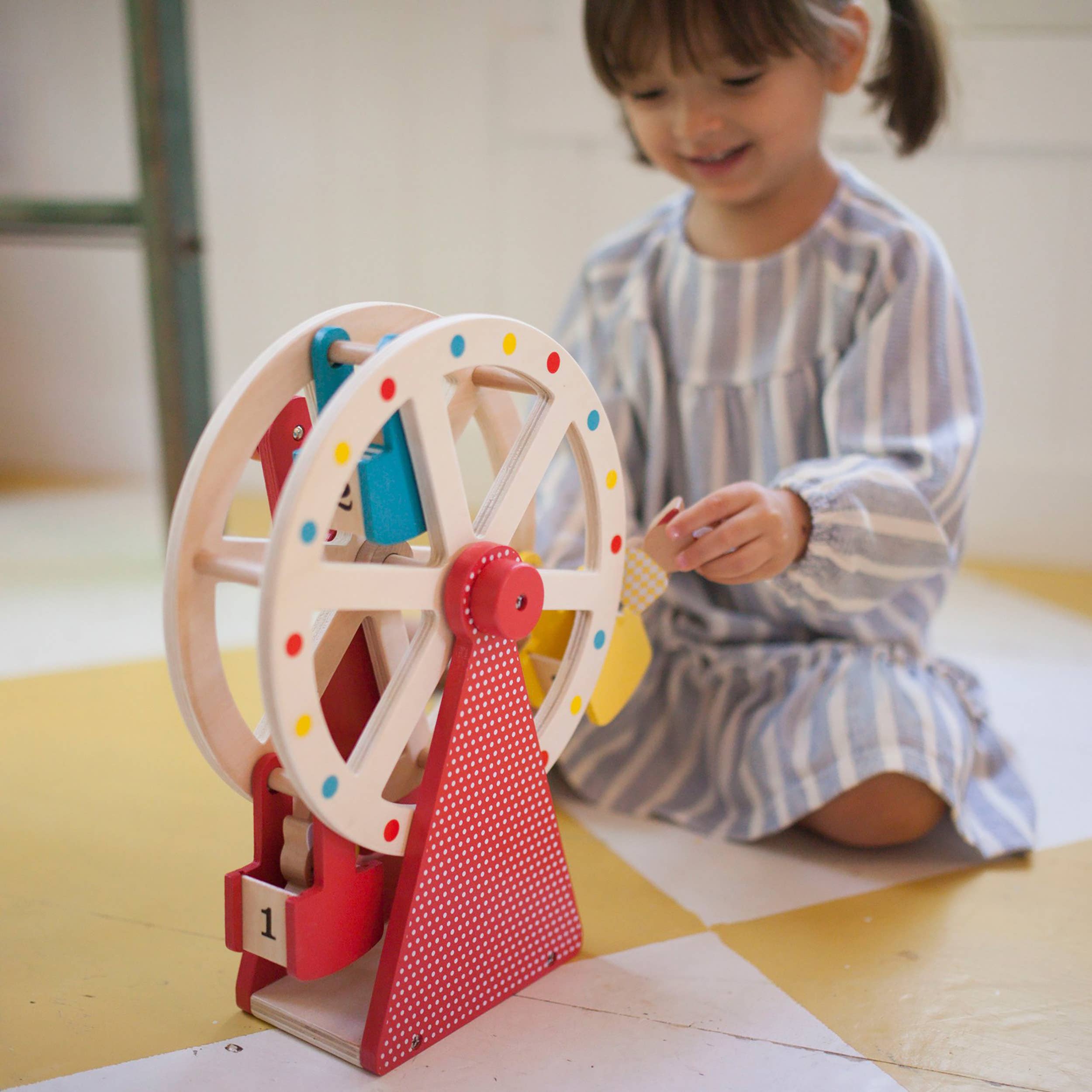 little girl paying with Wooden Ferris Wheel Carnival Play Set