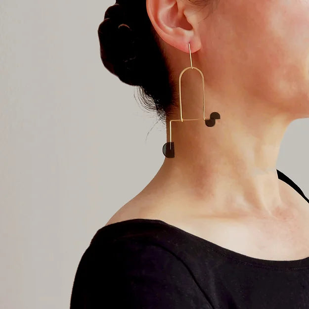 gold mobile earrings with black semi circles