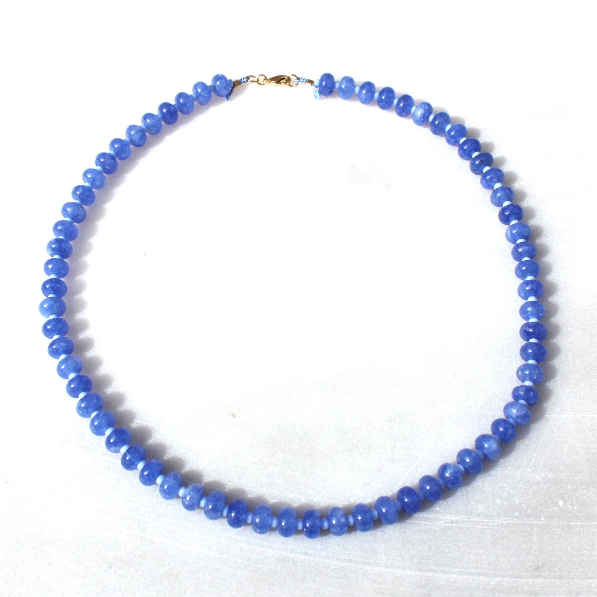 The Cornflower Stone Candy Beaded Necklace by The Silver Wren displayed on a white background, highlighting the beautiful jade stones in varying shades of blue.
