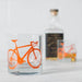 whiskey glass with orange bike print