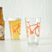 pint glass with orange bike
