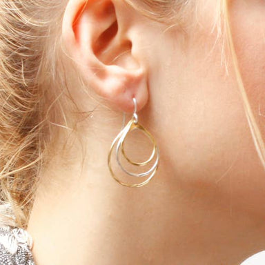 Elegant Tiered Teardrop Earring featuring three hammered teardrop rings, available in Brass and Silver, measuring 1.13 inches wide by 1.32 inches long.
