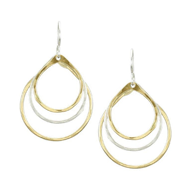 Tiered Teardrop Earring by Marjorie Baer showcasing three hammered teardrop rings in brass and silver. Delicate and elegant design with graceful movement, perfect for easy wear.