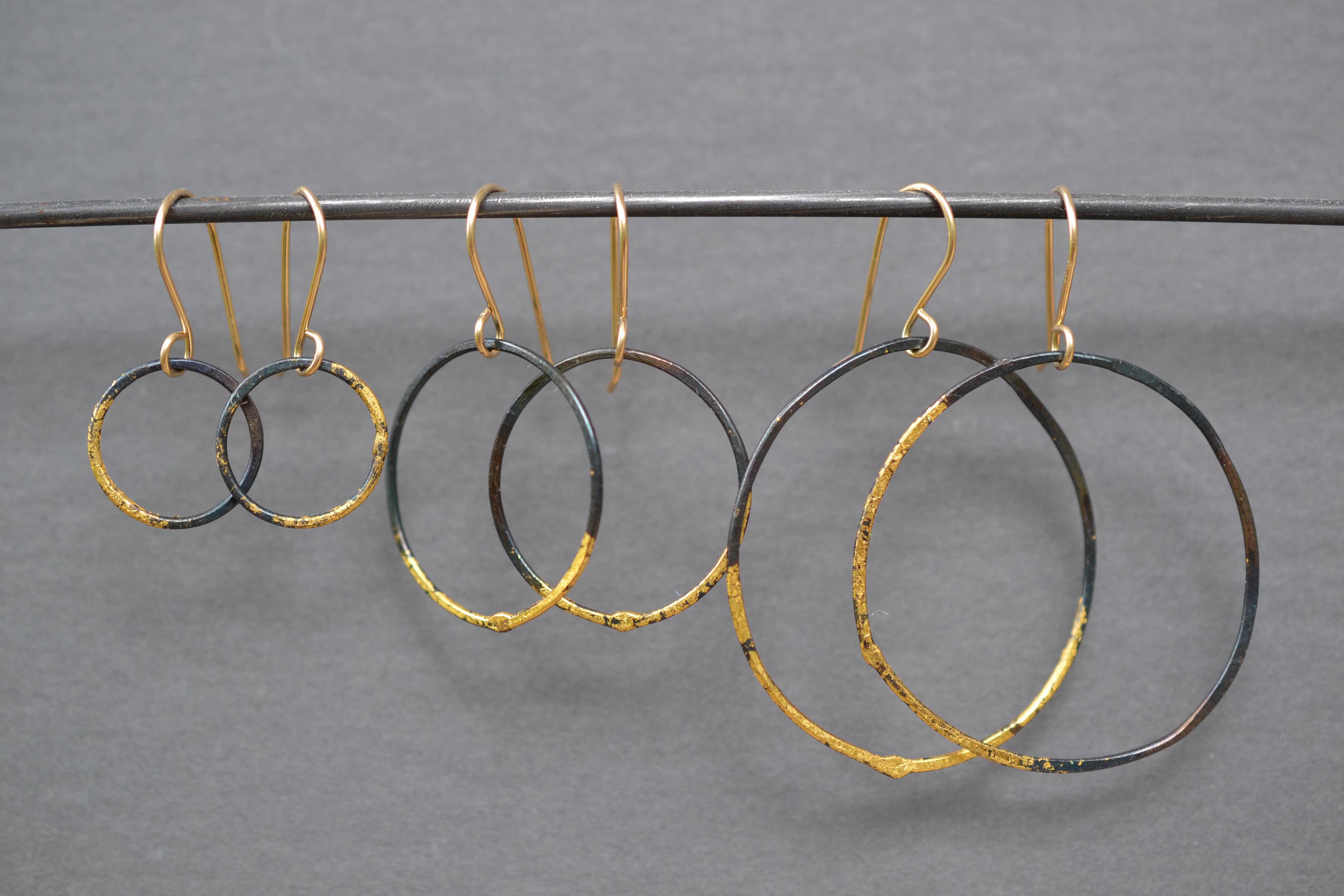 Small Steel and Gold Hoops, featuring a brush of 23k gold leaf on sleek blackened steel – because fashion should always come with a side of bling!