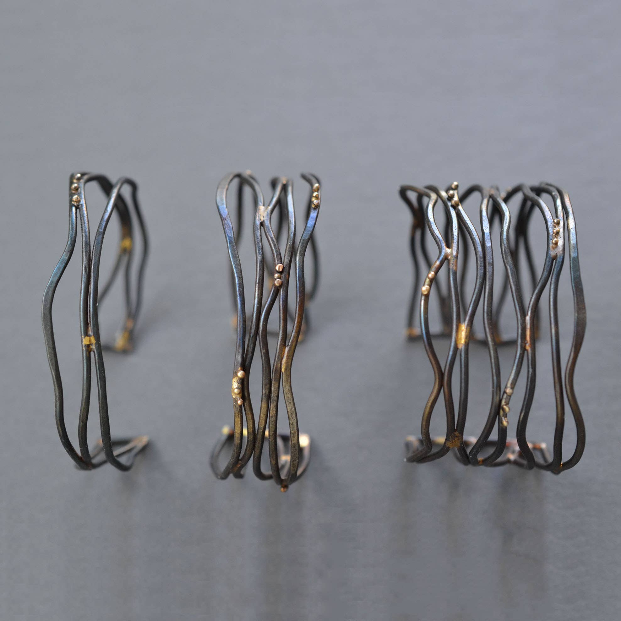 Close-up of the Narrow Organic Linear Cuff Bracelet, emphasizing the chic design with recycled 10K yellow gold accents—because your jewelry should be as eco-friendly as your coffee habit, right?