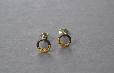 Steel and Gold Tiny Circle Studs close-up, showing unique blackened steel and 23k gold gilded details on petite circle earrings—small, stylish, and wonderfully low-maintenance.