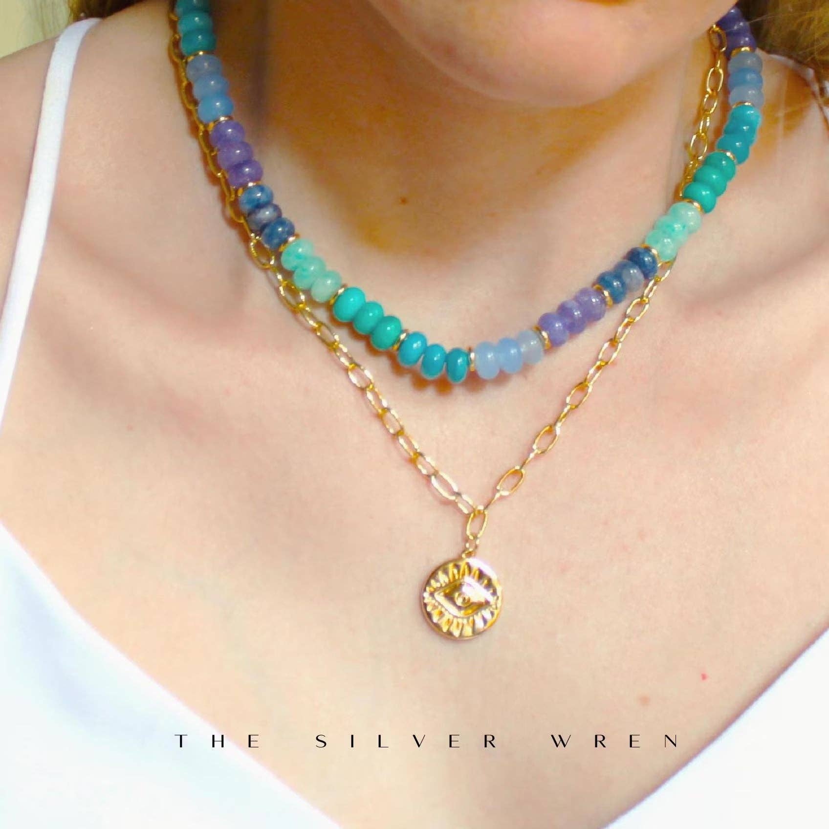 Ocean Stone Necklace layered with additional jewelry, showcasing vibrant beads and gold accents, modeled by a woman, by The Silver Wren.