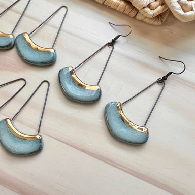A close-up of Turquoise Collar Ceramic Earrings with Gold Line, showcasing the elegance and the 'handmade feel', perfect for any ear's luxury.