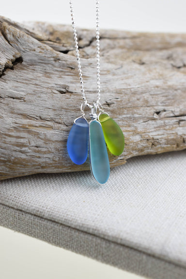 Eco Glass Trio Sterling Silver Necklace featuring three smooth frosted Eco Glass drops in vibrant ocean colors, elegantly crafted for coastal chic style.