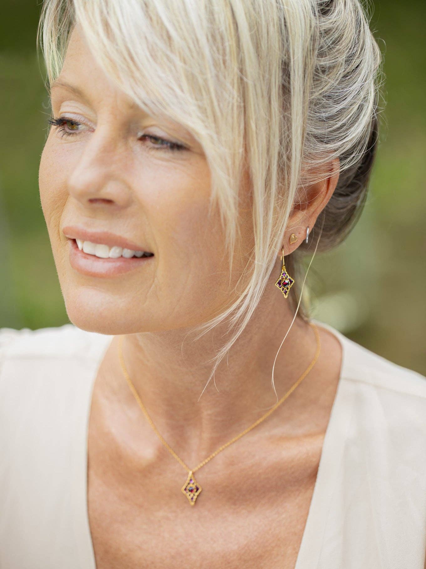 Esme Earrings in action! Perfect for swaying with your dance moves and stealing the show with garnet sparkle. Time to shine like you mean it!