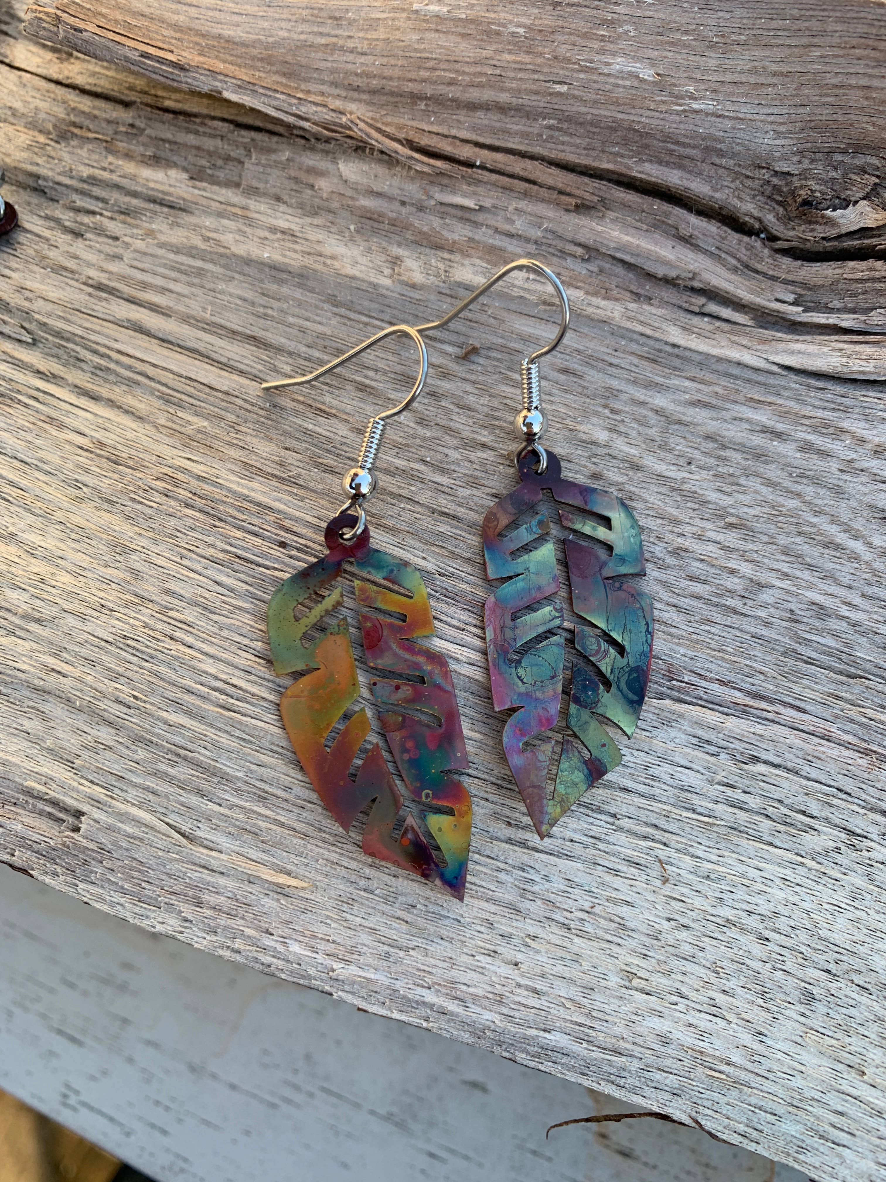 Western Feather Copper Earrings showcasing unique fire-painted designs with multiple colors and patterns.