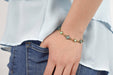 Person wearing Antiqued Gold bracelet with green opal gemstones 