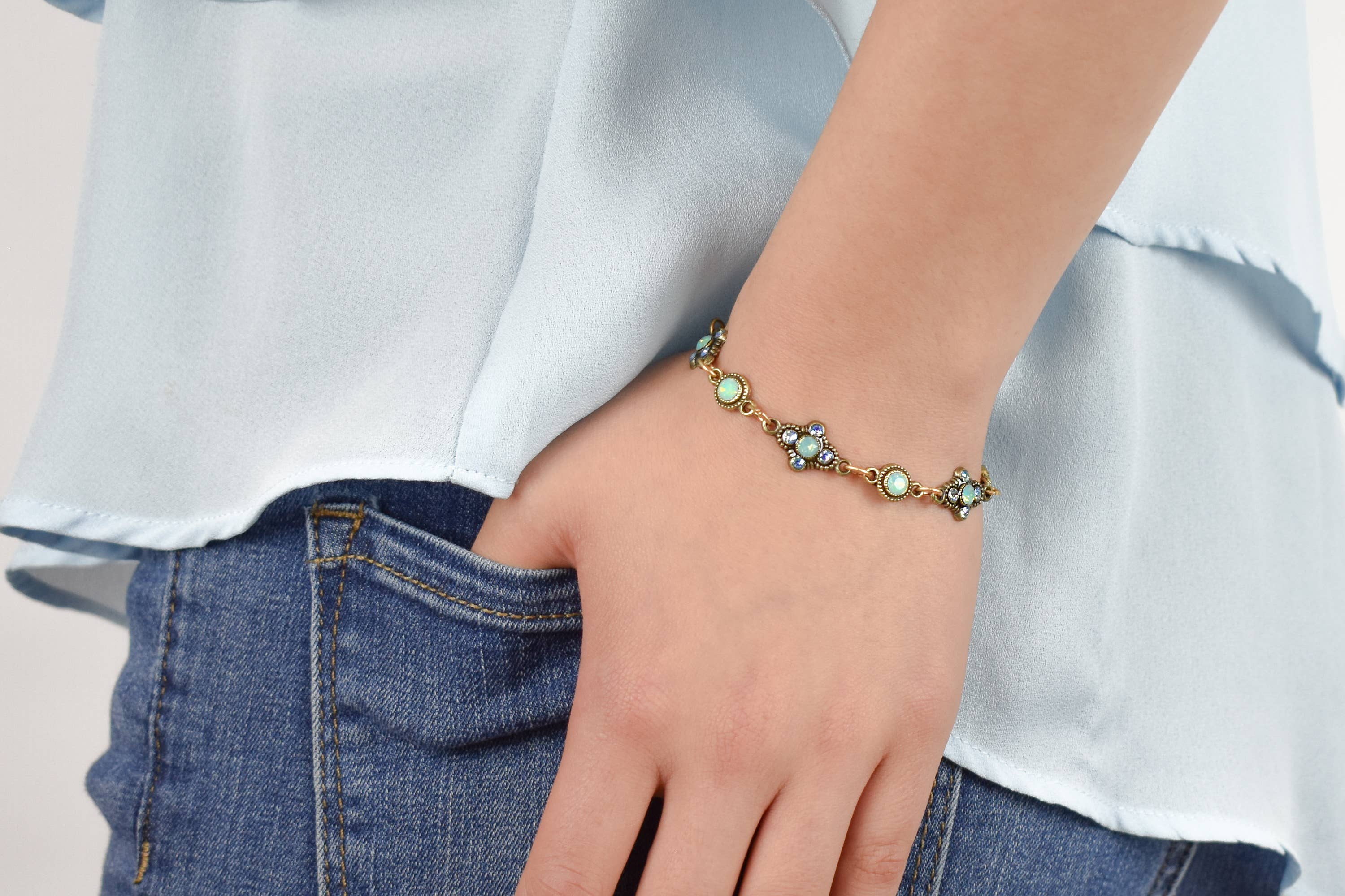 Person wearing Antiqued Gold bracelet with green opal gemstones 