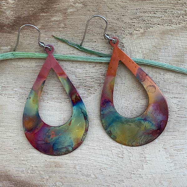 A model wearing the Boho Large Open Teardrop Fire Painted Copper Earrings, demonstrating their lightweight style and beauty.