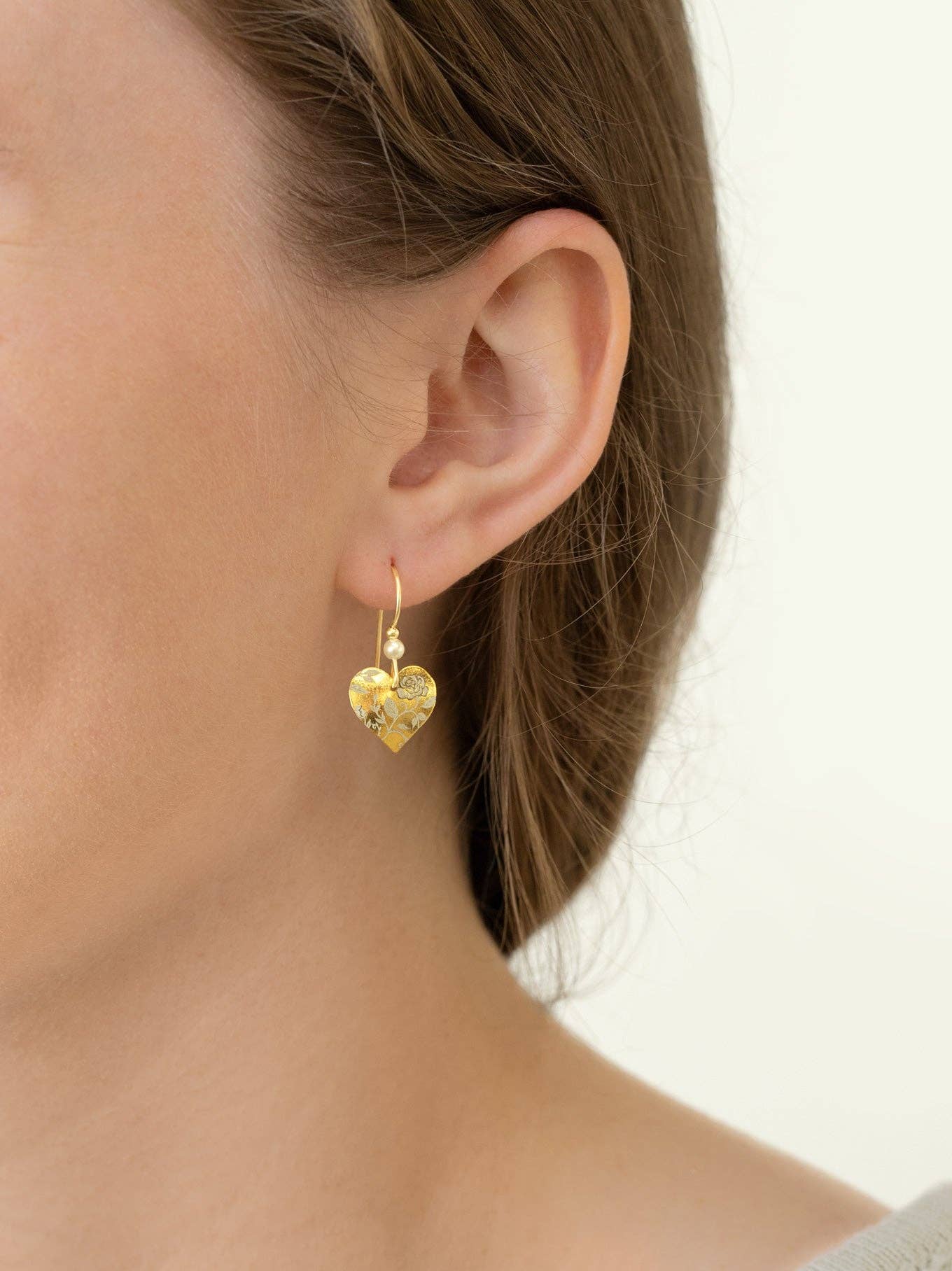 Budding Heart Earrings showcased with style - handcrafted by Holly Yashi, these earrings are the perfect mix of poetry and playfulness, complete with gold fill and niobium!