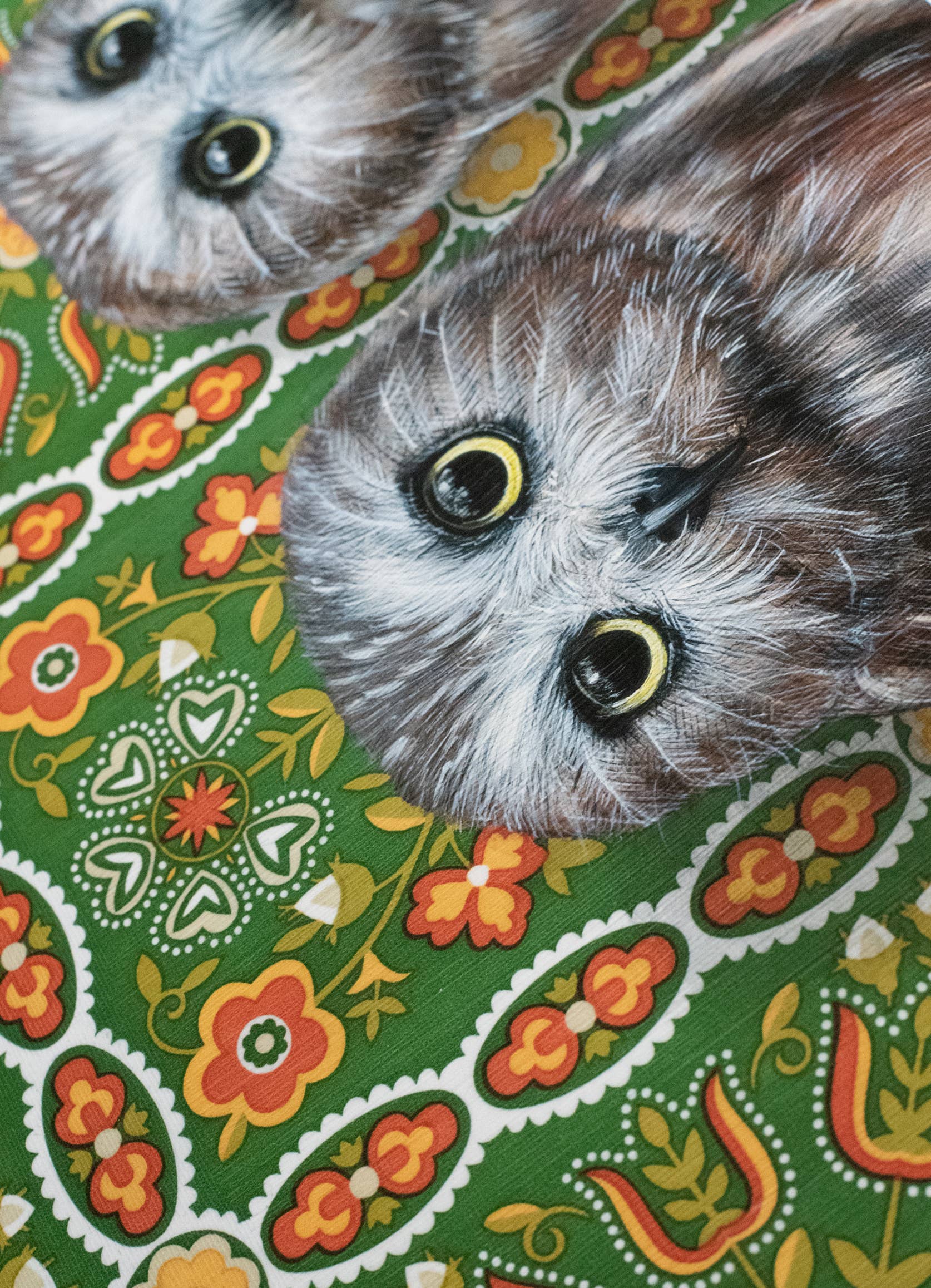 Framed art print of two owls on a patterned background.