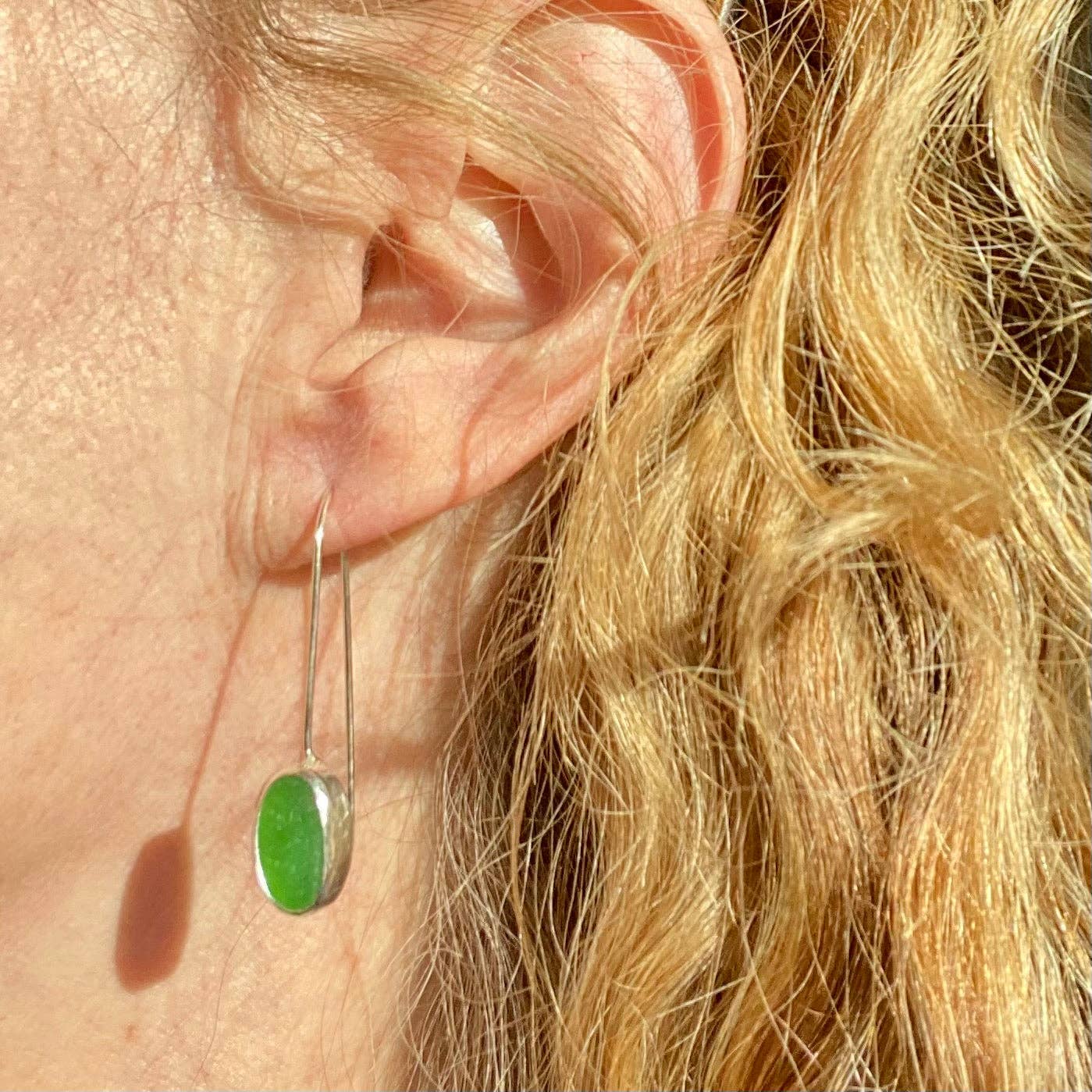 woman wearing green seaglass drop earring