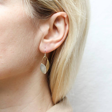 Close-up of Small Leaves and Ring Wire Earring by Marjorie Baer worn on an ear, showcasing the artisanal craftsmanship and elegant layered leaves.