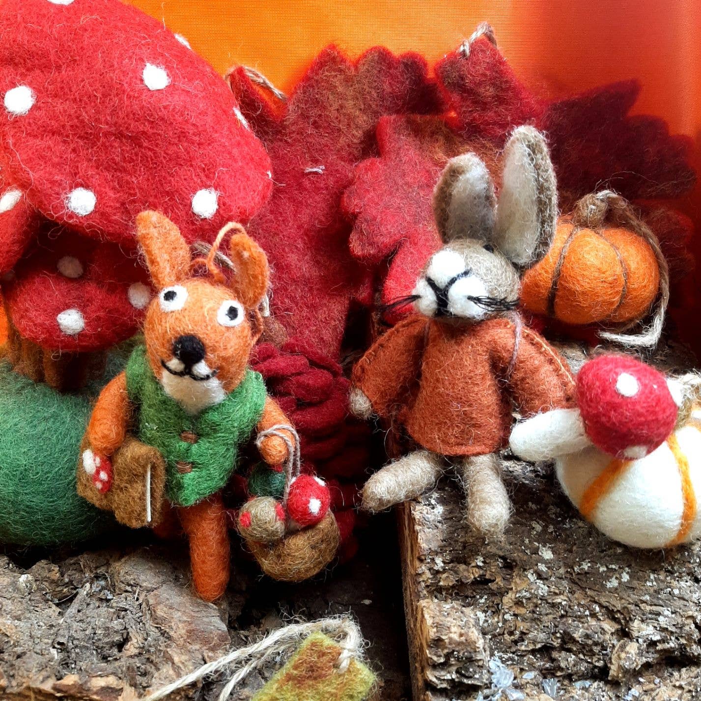 Felted fox and rabbit ornaments, with autumn-themed decorations.