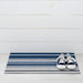 Horizon Stripe Shag Mat in Deep Sea by Chilewich, showcasing its vibrant waves of color and looped texture, perfect for entryways and patios.