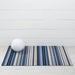 Close-up view of the Horizon Stripe Shag Mat in Deep Sea by Chilewich, highlighting the resilient vinyl backing designed for both indoor and outdoor use.