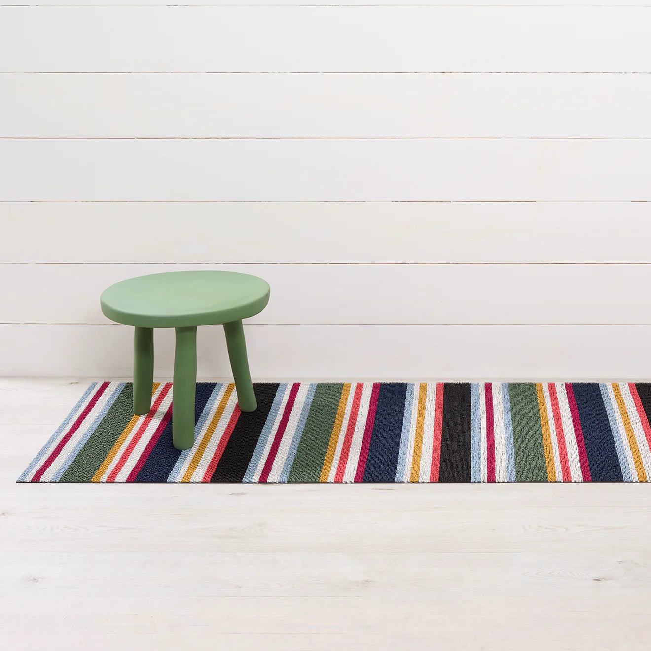 Shuffle Stripe Shag Mat displayed in a stylish entryway, combining both elegance and durability.